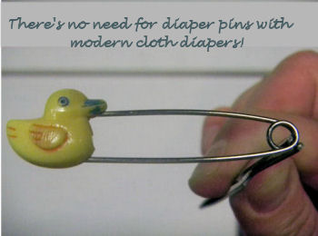 Old-fashioned, vintage baby ducky, yellow duck diaper pins.