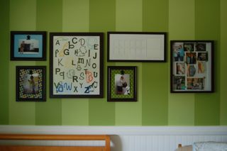 Artwork on the nursery walls includes an ABC letter collage and framed personal photographs