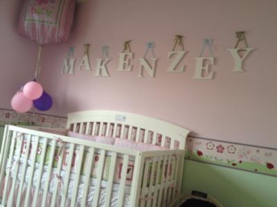 The upper portion of our baby girl's nursery wall is bubblegum pink is separated from the lower third  painted in fresh spring green by a cute ladybug wallpaper border