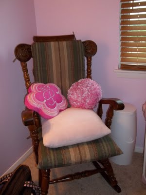 Our baby girl's nursery rocker with brown and pink cushions and throw pillows