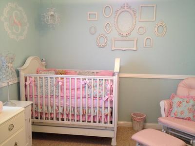 Elegant vintage style crib and DIY wall arrangment in a baby girl shabby chic nursery design using a variety of antique  picture frames as wall decor