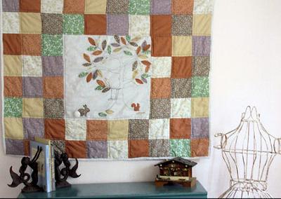 Squirrel and Bunny Patchwork Baby Crib Quilt in Fall Colors.  I love the calico bunny applique's fluffy Pom Pom tail!  