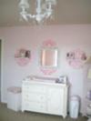 The Changing Area, Chandelier and Wall Decorations in our Whimsical and Elegant PInk Dreamland Baby Nursery Decor