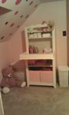 This pretty pink and white piece of nursery furniture makes organizing baby's items easy!