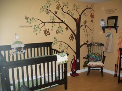 Our hand-painted tree wall mural with monkeys swinging through the branches surrounded by fluttering butterflies.   