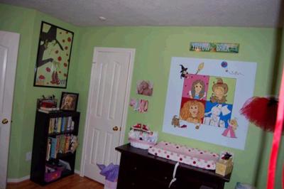 Another Wizard of Oz mural over the changing table featuring the main characters  and a view of the rest of  the nursery.