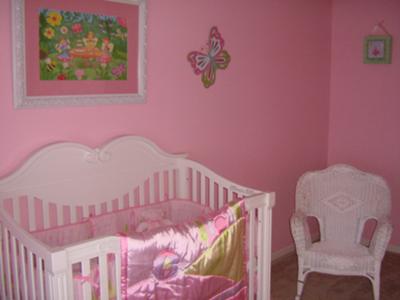 Joy's baby crib and nursery rocking chair with her pink Winnie the Pooh Crib bedding set.