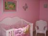 Joy's baby crib and nursery rocking chair with her pink Winnie the Pooh Crib bedding set.
