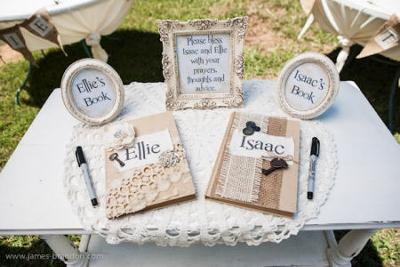 Guests are invited to share prayers, special thoughts and advice in personalized books at the entrance to the two sisters' vintage baby shower