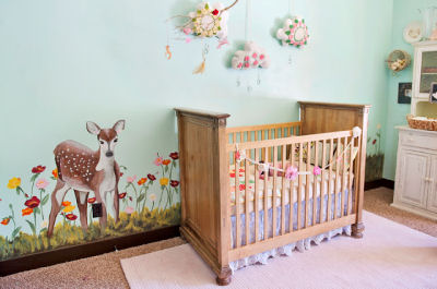 This baby girl's vintage mountain meadow nursery theme includes an original mural featuring a whitetail deer fawn and flowers painted by her aunt and mother. 