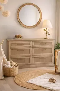 Slim natural fluted wood nursery dresser styled in a small nursery with crib
