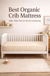Best organic crib mattress in a calm neutral nursery with a natural wood crib and soft layered bedding