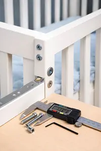 Baby crib corner with crib screws and hardware secured correctly during assembly