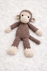 Soft crochet monkey lovey pattern made with plush yarn and floppy limbs for baby security comfort