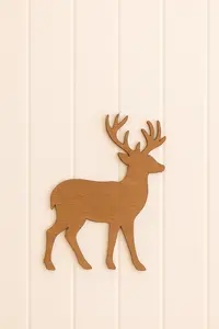 DIY wooden deer nursery wall sign made with a warm wood silhouette mounted on a neutral wall