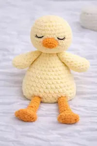 Soft crochet duck lovey snuggler designed for babies to hold and cuddle