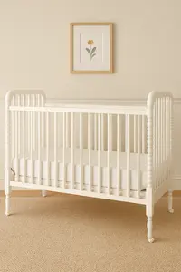 Classic vintage white Jenny Lind spindle crib showing turned spindles and traditional nursery design