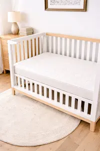 Newton crib mattress in a modern baby crib with a clean neutral nursery look