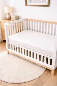 Newton crib mattress in a modern baby crib with a clean neutral nursery look