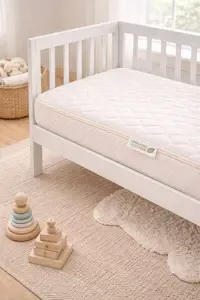 A crib in a nursery with an organic cotton crib mattress