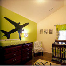 Baby girl's green and black airplane theme nursery with damask crib bedding