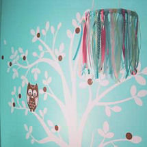 Pink and aqua blue wise owl baby girl nursery with a tree wall decal and ribbon crib mobile