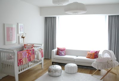 Beautifully decorated baby girl nursery room in pink gray  and white with a Moroccan silver metallic pouf accent decoration