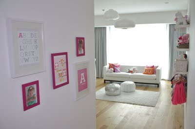 Personalized baby nursery wall art in magenta and white picture frames in an attractive arrangement