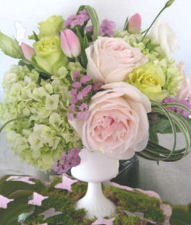 Spring butterfly baby shower theme table centerpiece floral arrangement with pink sweetheart roses green hydrangea butterflies and flowers with greenery in a white vase