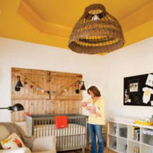 Rustic nursery with barn board features and mustard yellow tray ceiling