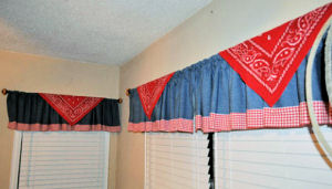 Baby boy western cowboy nursery window valance. Rustic blue denim curtains with a red gingham check border.