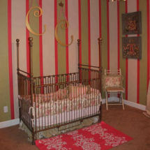 Pink white and green French baby girl nursery with iron crib and gold wall letters