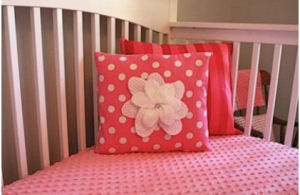 A pink and gray nursery for a baby girl nursery.