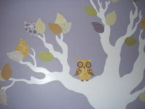 A Lilac nursery wall paint color with a homemade DIY tree wall decal made of fabric cut outs