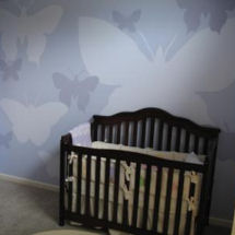 Modern blue baby girl butterfly nursery with crib and butterfly wall painting technique