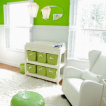 Bright modern neutral lime green and white baby nursery with solid white glider rocker and faux fur flokati area rug