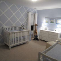 Baby boy powder blue white and green nursery with painted lattice pattern on the wall