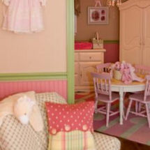Pink, antique white and green vintage baby girl nursery with polka dot fabrics and victorian wall decorations