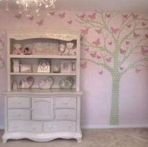 Pink tree wall decal with butterflies in a pink and white baby girl princess nursery
