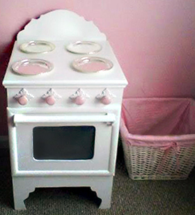 The wooden pink and white princess stove we made using woodworking plans we found online is so sweet and only cost $25!