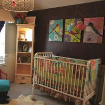 Bold colorful baby girl nursery with dark purple and charcoal gray paint color on the walls