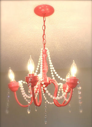 Recycled watermelon pink nursery chandelier decorated with faux jewels and garland