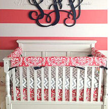 Pink and white painted horizontal wall stripes in a baby girl nursery