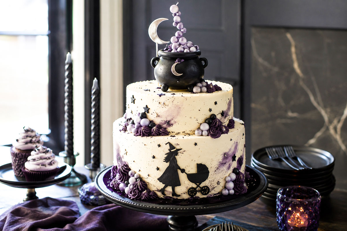 A Baby Is Brewing Halloween baby shower cake with a small cauldron, crescent moon and bubbling frosting details