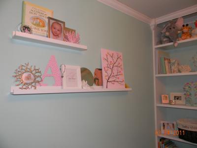 Wall shelves with decorations from previous nurseries and my own room when I was little.  I made the pink letter 