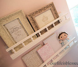 Nursery wall shelves with photos in vintage frames