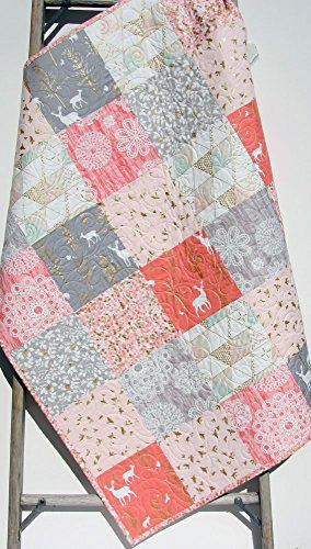 handmade patchwork baby quilt for a girl in a pink and metallic gold woodland forest animal fabric patterns