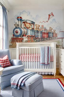 Baby Seamus teddy bear train nursery with a painted mural and red and blue gingham bedding