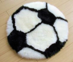Black and white soccer ball sheepskin baby rug for a sports theme nursery