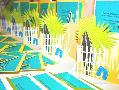 Homemade beach theme baby shower invitations with flip flops surf boards in the sand and palm trees